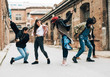 © Bonninstudio/Stocksy - Group of friends dancing hip hop on the street.