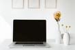 © Alina Hvostikova/Stocksy - Laptop and flowers on table
