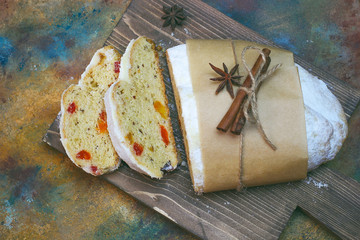 Wall Mural - Christmas Stollen. Traditional Sweet Fruit Loaf with Icing Sugar on colorful background.Copy space