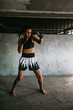 © Mosuno/Stocksy - Kickboxing woman training in old gym