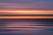 © Tim Booth Photography/Stocksy - Purple and orange blurred seashore