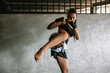 © Mosuno/Stocksy - Kickboxing woman training in old gym