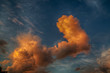 Large fiery orange thick clouds at sunset in sky with wispy clouds, HDR.