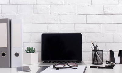 Laptop with blank space for advertisement and office accessories
