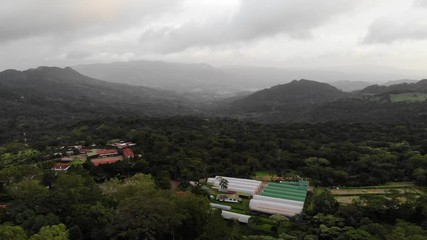 Wall Mural - Big farm on mountain hills above drone view on sunset light