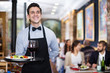 © JackF - Smiling waiter with serving tray in restaurant