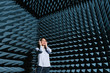 © Hernandez And Sorokina/ADDICTIVE STOCK - Beautiful young woman enjoying music in modern sound room with spiky walls