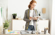 © Prostock-studio - Dressmaker using tablet to check customer order list
