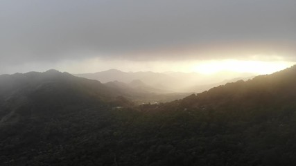 Wall Mural - Sunset over mountain valley aerial above drone view