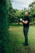 © Ramon Lopez/ADDICTIVE STOCK - Caucasian man trimming an arizonica hedge with mechanical tools