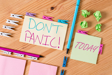 Handwriting text writing Don T Panic. Conceptual photo suddenly feel so worried or frightened that you can not behave Colored clothespin papers empty reminder wooden floor background office