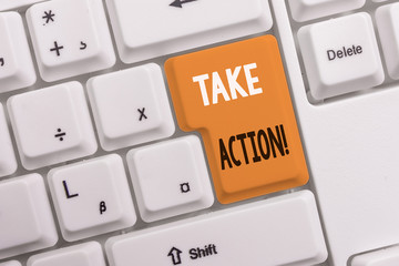 Text sign showing Take Action. Business photo text do something official or concerted to achieve aim with problem White pc keyboard with empty note paper above white background key copy space