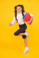 Wall Mural - Active child in motion. Beginning school lesson. Keep going. Active kid. Hurry up. Girl with books on way to school. Knowledge day. Back to school. Kid cheerful schoolgirl running. Pupil want study