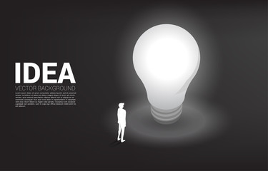 Poster - Silhouette of businessman standing with light bulb . Business Concept of creative idea and solution.