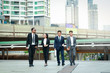 © SUPERMAO - Four Asian businessmen discuss work and financial investments.