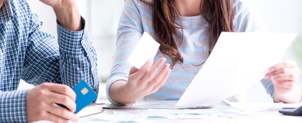 Young couple looking at family finance papers