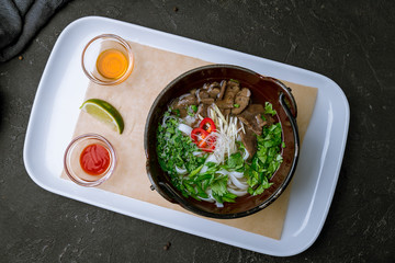 Soup Pho Bo on black concrete table