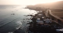 Beach Homes And Properties On The Beach During Sunset. Peaceful Waves Create A Beauitful Atmosphere And Environment For Quiet Living. Shot From Above In 4k.mov