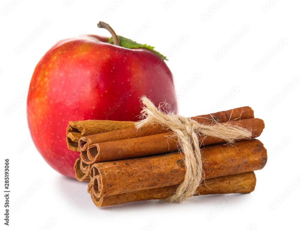 Fresh apple with cinnamon on white background