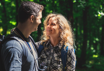 Young couple enjoying hiking together in forest.