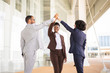 © Mangostar - Happy joyful business colleagues celebrating success. Multiethnic team of man and women giving high five to each other. Team success concept