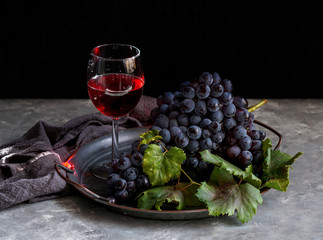 dark bunch of grape with water drops in low light, red wine, dark photo with copy space               