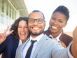 © Mangostar - Joyful multiethnic business people taking group selfie. Self portrait of happy business man and women showing peace gesture. Multiethnic team concept
