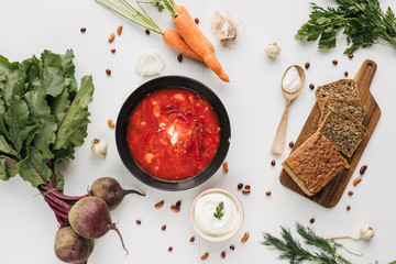 The main ingredients - vegetables for cooking borsch (beetroot, cabbage, carrots, potatoes, tomatoes). Top view.