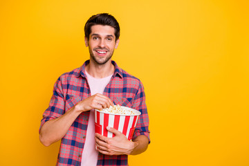 Sticker - Photo of enjoying man watching his favorite movie and eating pop corn while isolated with yellow background