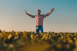 © Zoran Zeremski - Portrait of farmer standing in soybean field at sunset with his arms outstretched.
