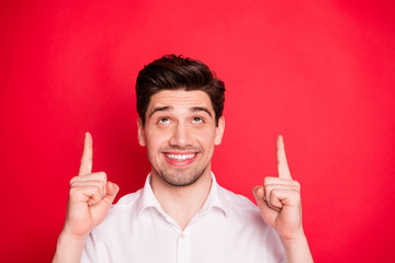 Canvas Print - Close-up portrait of nice attractive cheerful cheery glad positive funny content guy pointing two forefingers up holiday gift surprise present ad advert isolated over bright vivid shine red background