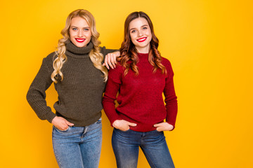 Poster - Photo of two amazing ladies standing close wear knitted sweaters isolated yellow background