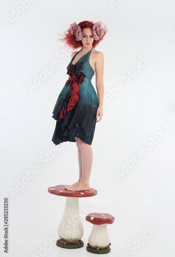 Full Length Portrait Of Red Haired Girl Wearing Fairy Costume