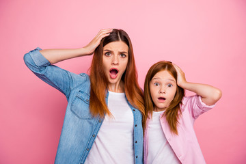 Poster - Portrait of impressed ginger haired girls with long hairstyle staring screaming wearing denim jeans shirt isolated over pink background