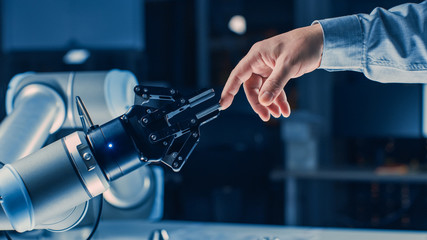 Leinwandbilder - Futuristic Robot Arm Touches Human Hand in Humanity and Artificial Intelligence Unifying Gesture. Conscious Technology Meets Humanity. Concept Inspired by Michelangelo's Creation of Adam