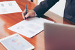 © zeeclock1 - Business man signing documents on table at office.