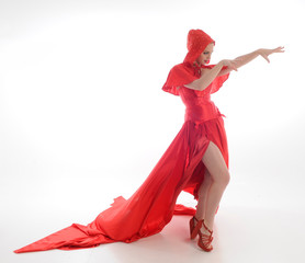 Wall Mural - full length portrait of woman wearing red riding hook cloak and long silk gown. standing pose, isolated on white studio background