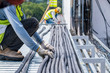 © Attapol - Workers are moving cables in construction sites.