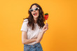 © Drobot Dean - Happy cute young woman posing isolated over yellow wall background holding candy lollipop.