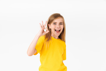 Wall Mural - Portrait of happy blonde summer girl wearing casual t-shirt smiling and showing ok sign