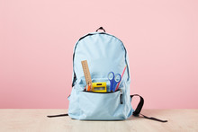 School Blue Backpack With Stationery In Pocket Isolated On Pink