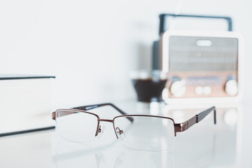 Glasses with radio, book and coffee