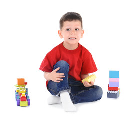 Sticker - Cute little boy playing with toys on white background