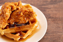 Pile Of Chicken And Waffles On A Rustic Wooden Counter