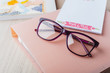 Woman glasses with planner and books