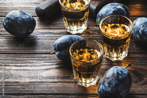 Fotomural  Slivovica - plum brandy or plum vodka, hard liquor, strong drink in glasses on o