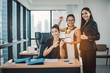 © Yingyaipumi - Succesful and happy business women concept.Young group business woman holding a trophy on office background