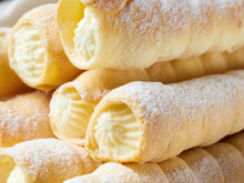 Close-up of custard tube of pastry filled with cream