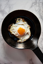 One Sunny Side Up Egg In A Cast Iron Frying Pan
