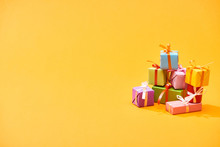 Stack Of Colorful Festive Boxes On Bright Orange Background